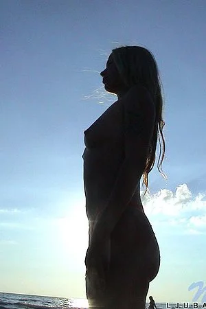 Young fair haired lass Ljuba Nubiles dressed in panties poses on peopleless beach