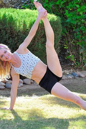 Flexible doll Bella Bends taking cloth by cloth and finally doing gymnastics nude outdoor