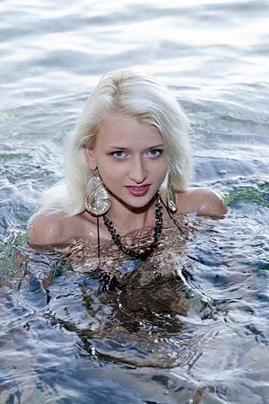 Nika N is a stunning blonde teen who is stripping at the beach and touching herself 