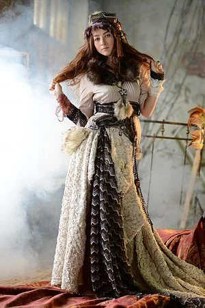 Redhead teen Ruzanna A takes off her intricate outfit and shows us her delicious butt