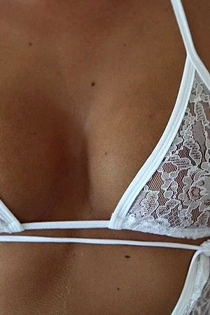 Becky Stevens in white lace lingerie gives a close-up of her bald pussy outside