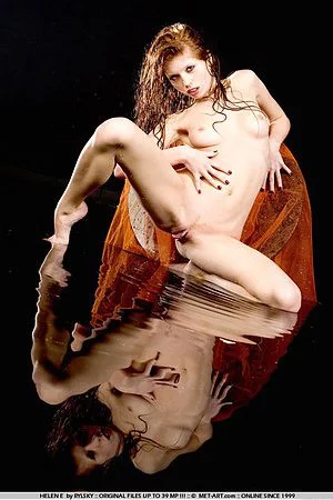 Red-haired nude model Helen E with nicely shaved pussy shows off her slim wet body