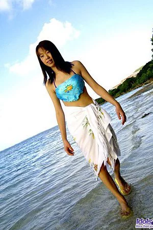 Asian girl Hikari Idols is staying in the sea water exposing nude charms to the sun