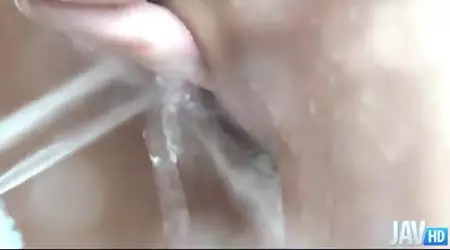 Asian babe Haruka Oosawa dips her fine bod in a bath and masturbates with shower head